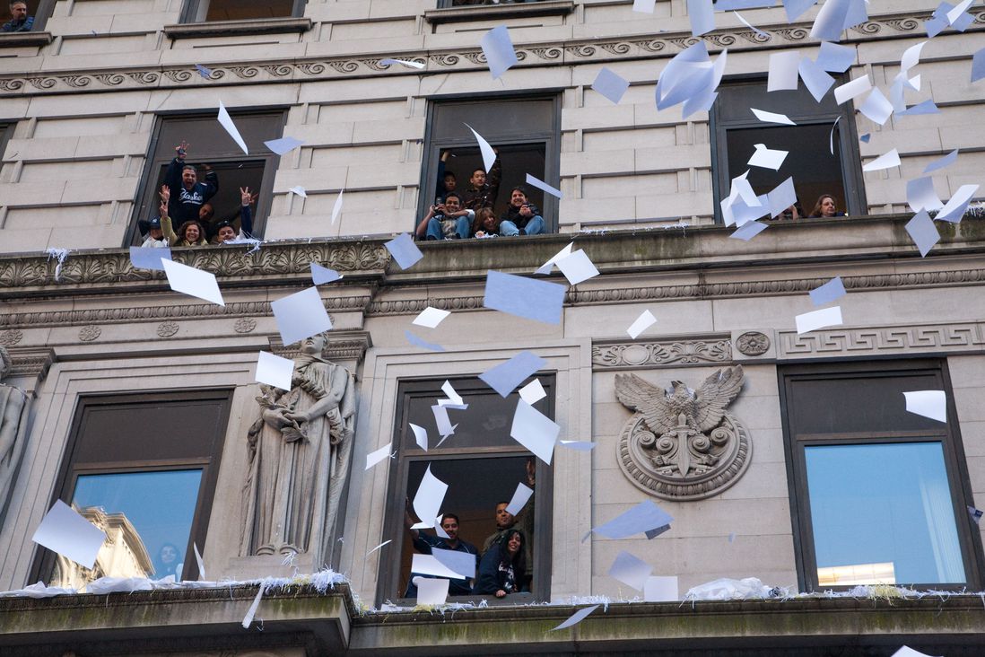 Pieces of paper flying out of windows during the 2009 parade for the New York Yankees (Erik Pendzich/Shutterstock)